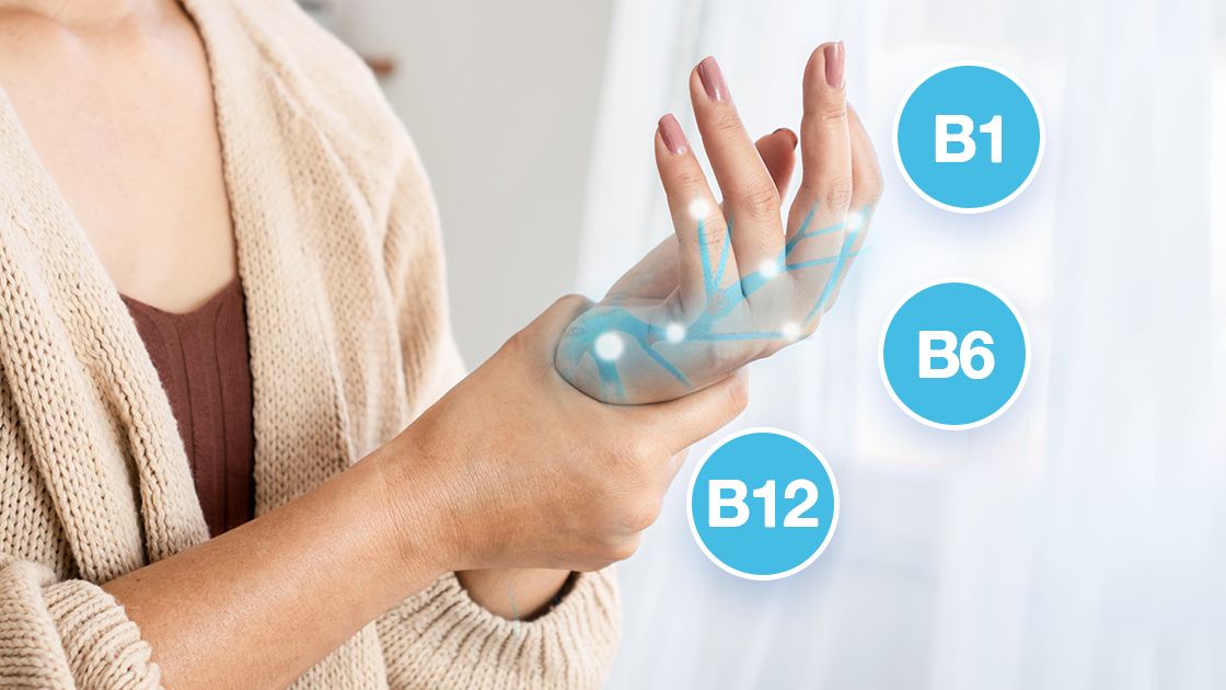 A woman holding and massaging her left palm surrounded with nerve elements, B vitamins, and blue circles around her hand.