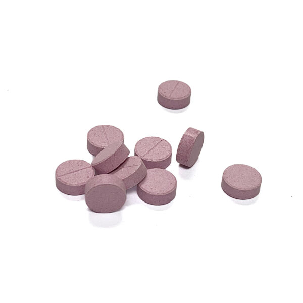 Pinkish chewable tablets, rounded shape. White background.